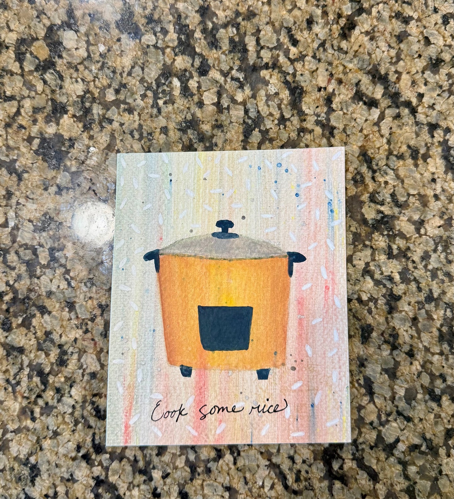 Original artwork with a colorful background and an illustration of a rice pot with grains of rice all around it.