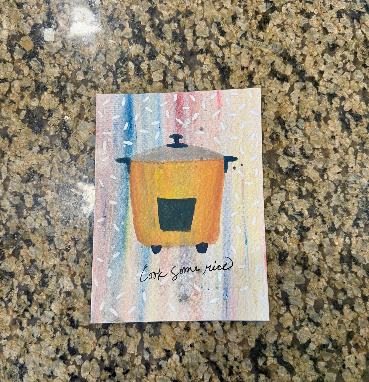 Original artwork with a colorful background and an illustration of a rice pot with grains of rice all around it.